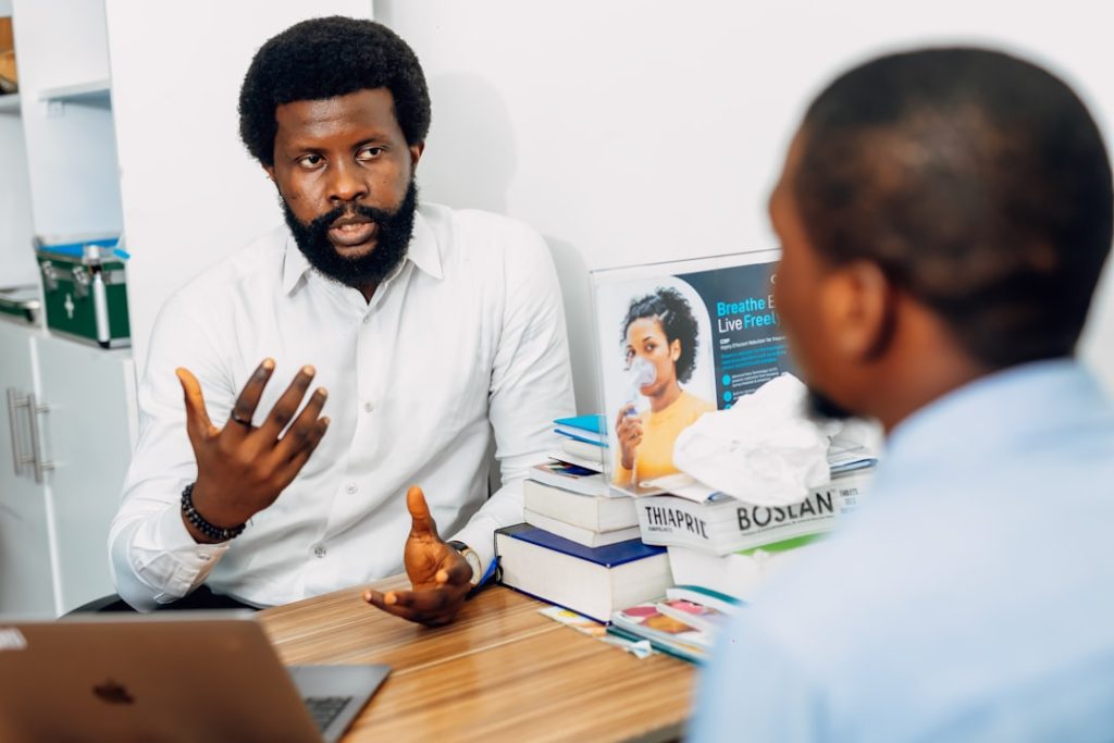 A doctor speaking to his patient at the hospitals office. Find more afro-centric images at www.ninthgrid.com